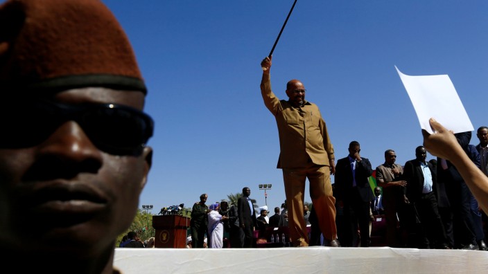 Sudan's President Omar al-Bashir waves to his supporters during a rally at the Green Square in Khartoum