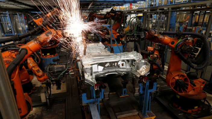 A welding robot creates sparks during the body shell production of a Ford Fiesta at the Ford assembly line in Cologne