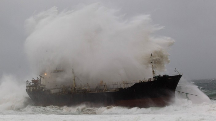 A wave crashes into a ship which broke free from a tow line at Sheffield Beach