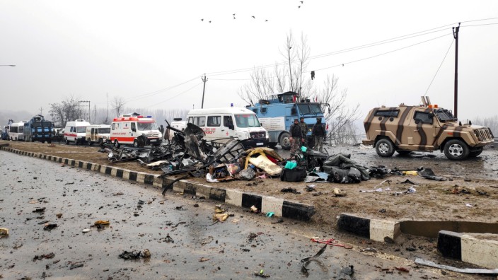 Indian soldiers examine the debris after an explosion in Lethpora in south Kashmir's Pulwama district