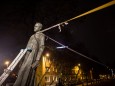 The monument of the late priest Henryk Jankowski is seen pulled down by activists in Gdansk