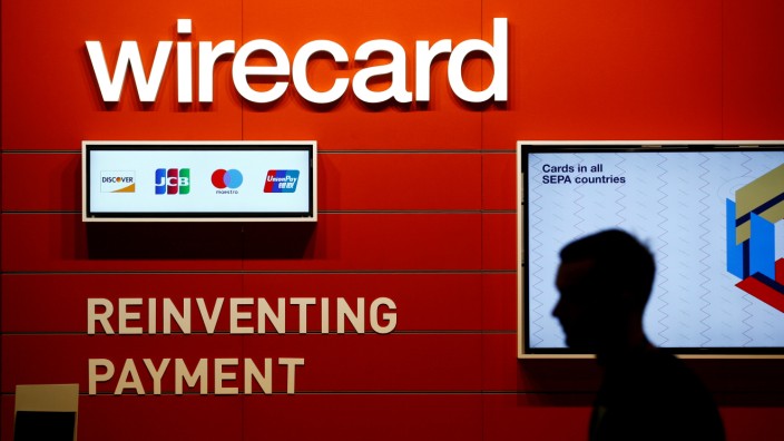 FILE PHOTO: A man walks past the Wirecard booth at the computer games fair Gamescom in Cologne, Germany, August 22, 2018.