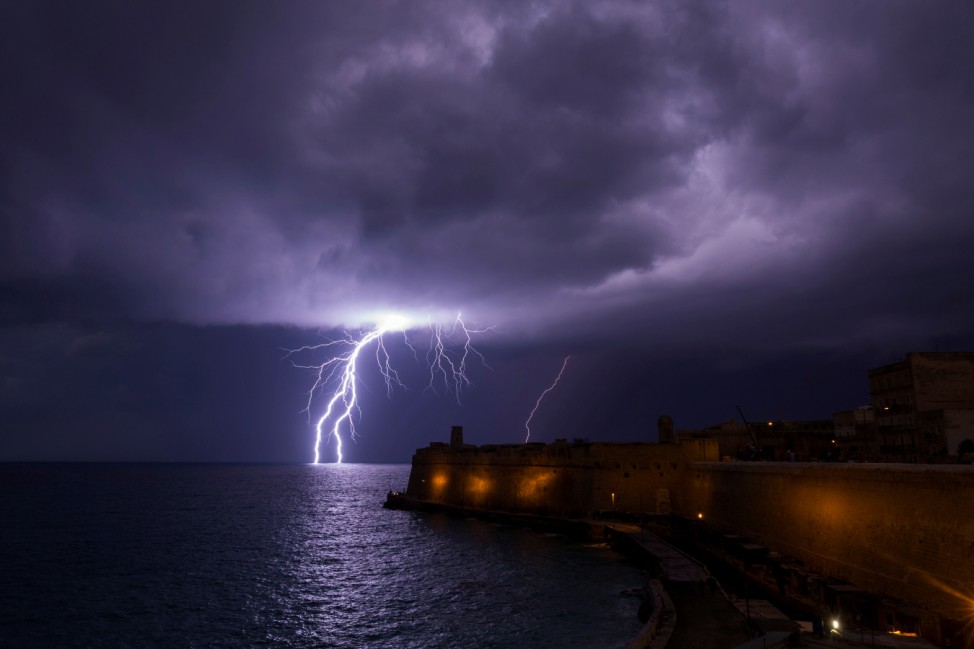 A lightning bolt strikes the sea near Fort St Elmo during a storm in Valletta