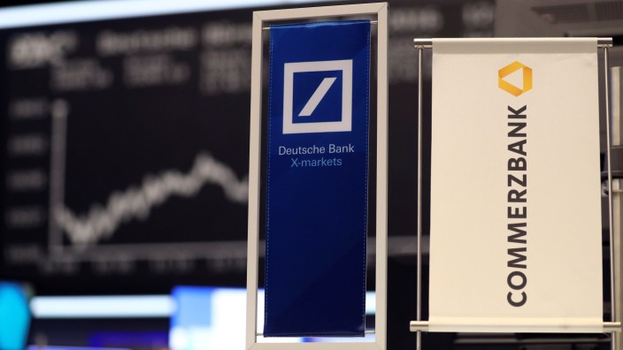 FILE PHOTO: Banners of Deutsche Bank and Commerzbank are pictured in front of the German share price index, DAX in Frankfurt