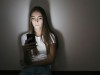 Young woman at home sitting on floor using cell phone in the dark model released Symbolfoto property