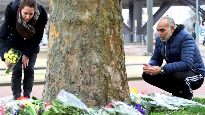 People place flowers at the site of a shooting in Utrecht