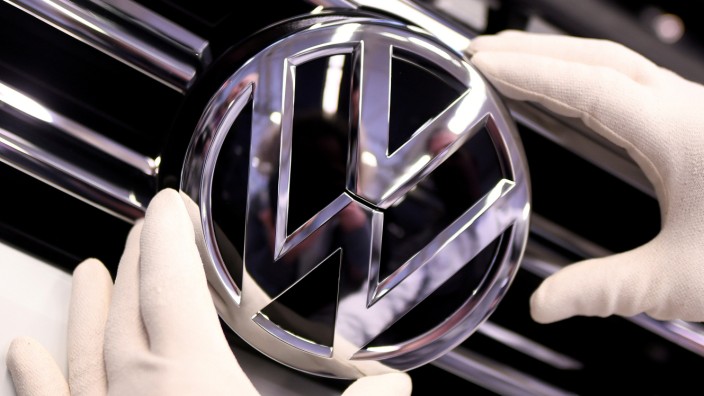 FILE PHOTO: A Volkswagen badge on a production line at the VW plant in Wolfsburg, Germany