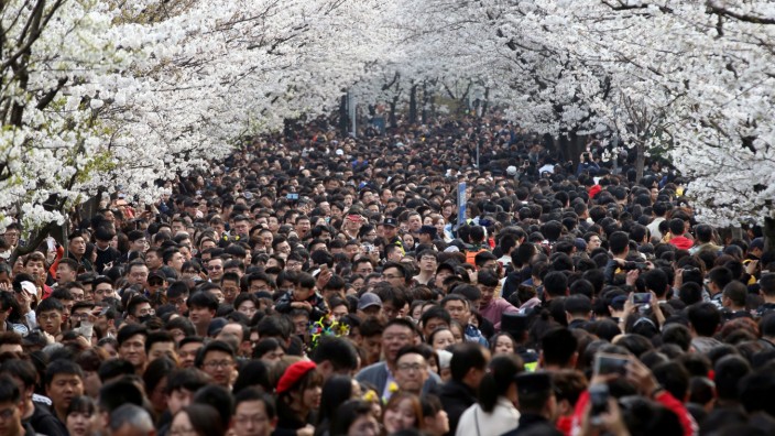 Visitors flock onto a street near Jiming Temple in Nanjing