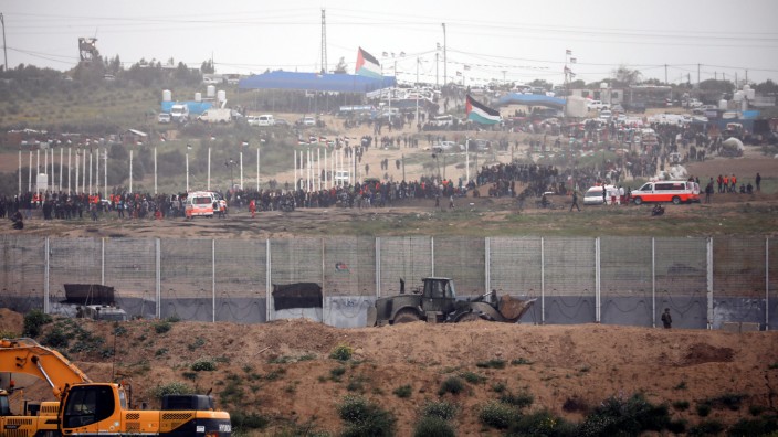Palestinians can be seen as they gather on the Gaza side of the border between Israel and the Gaza Strip, as it is seen from its Israeli side