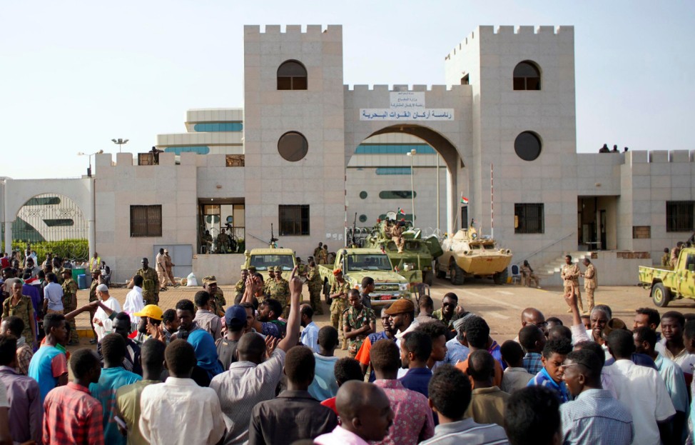 Sudanese demonstrators gather to protest against the army's announcement that President Omar al-Bashir would be replaced by a military-led transitional council, outside the Defence Ministry in Khartoum