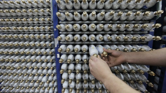 An employee sorts carbonator bottles while working at the SodaStream factory in the West Bank Jewish settlement of Maale Adumim