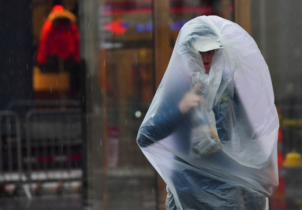 In die Tüte gekommen: Ein Teilnehmer des Boston Marathons schützt sich vor dem Regen.