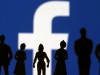 FILE PHOTO: Small toy figures are seen in front of Facebook logo in this illustration picture