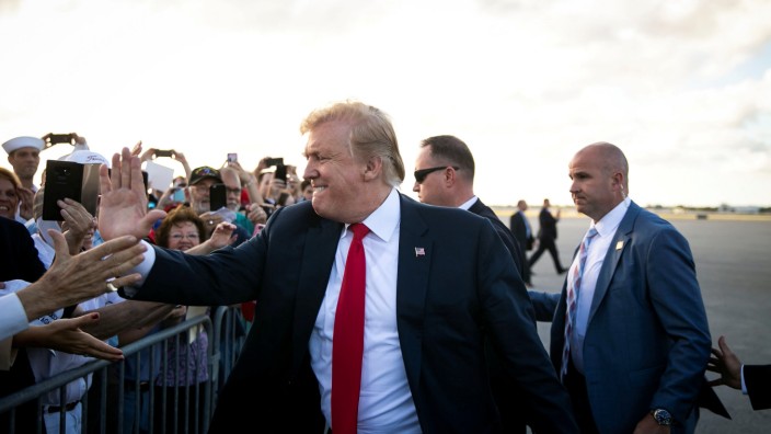 U.S. President Donald Trump greets supporters on the tarmac at Palm Beach International Airport, as he arrives to spend Easter weekend at his Mar-a-Lago club, in West Palm Beach