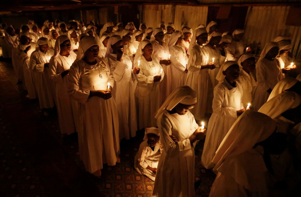 Christian faithful of the Legio Maria African Mission church hold candles as they attend the Easter vigil mass in their church in Fort Jesus area of Nairobi