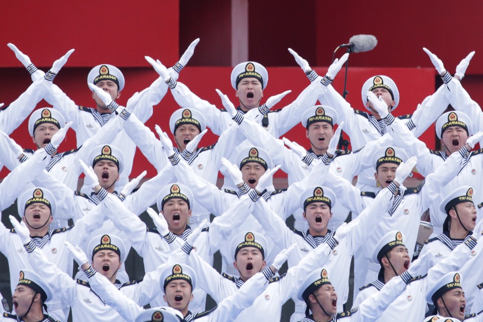 Chinese navy personnel perform at an event celebrating the 70th anniversary of the founding of the Chinese People's Liberation Army Navy (PLAN) in Qingdao