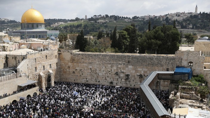 The Dome of the Rock is seen in the background as Jewish worshippers take part in a priestly blessing during the Jewish holiday of Passover at the Western Wall, Judaism's holiest prayer site, in Jerusalem's Old City