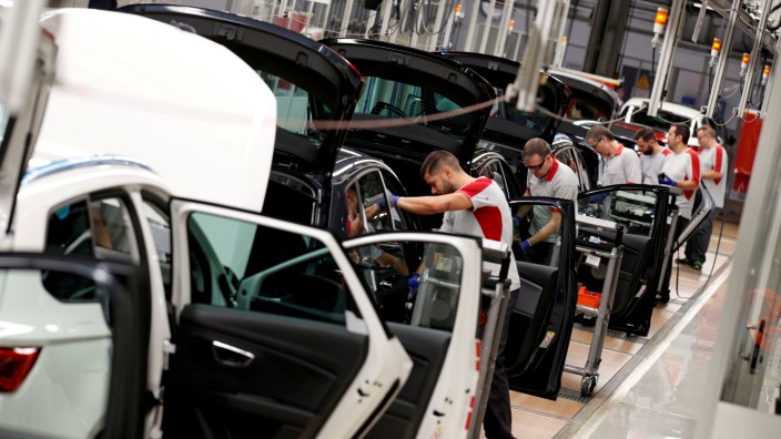 FILE PHOTO: Workers assemble vehicles on the assembly line of the SEAT car factory in Martorell