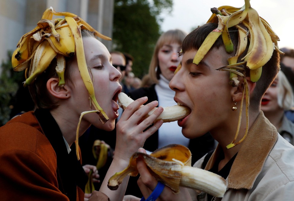 People eat bananas during a protest against perceived censorship by Poland's National Museum in front of the National Museum in Warsaw