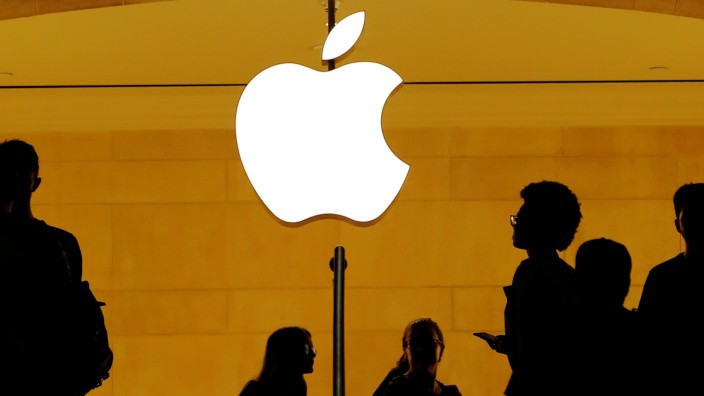 FILE PHOTO: Customers walk past an Apple logo inside of an Apple store at Grand Central Station in New York