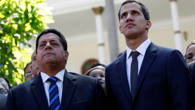 FILE PHOTO: Juan Guaido, new President of the National Constituent Assembly and lawmaker of the Venezuelan opposition party Popular Will, and lawmaker Edgar Zambrano of Democratic Action party, leave the congress in Caracas