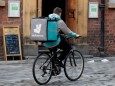FILE PHOTO: A deliveroo worker cycles along a pedestrianised road in Liverpool