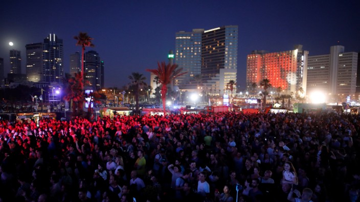 People gather at the fan zone near the beach at the eve of the 2019 Eurovision song contest final in Tel Aviv