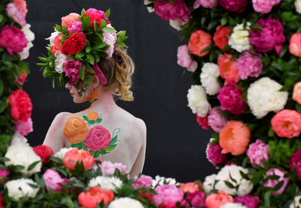 A model poses with body art and headwear made of Peonies at the RHS Chelsea Flower Show at the Royal Hospital Chelsea, London