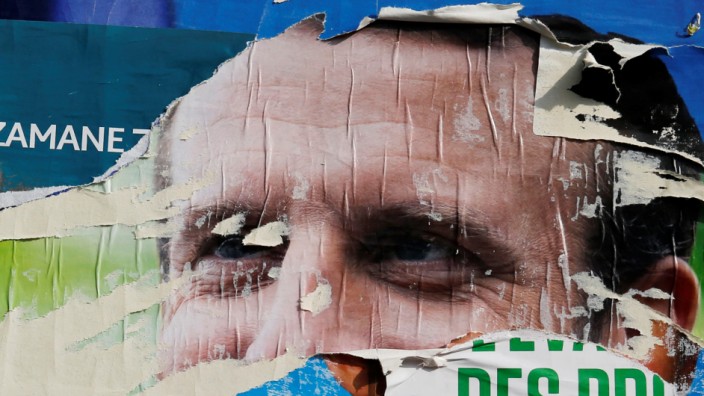 Torn and overlapping official posters of candidates for the 2019 European parliament elections including a poster of French President Emmanuel Macron as the cover for the Renaissance (Renewal) list, are seen in Cambrai