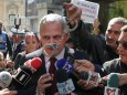 FILE PHOTO: A protester waves a pair of handcuffs in front of Social Democrat Party leader Liviu Dragnea in Bucharest