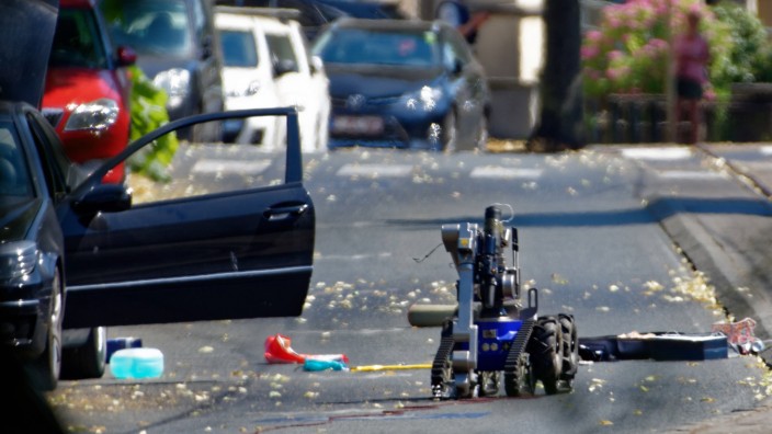 A bomb disposal robot inspects a suspect car in Woluwe Saint Pierre outside of Brussels Belgium on