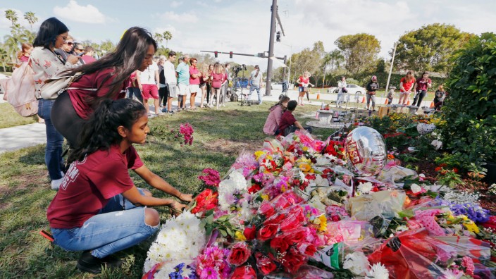 FILE PHOTO: Bouquets are placed at a memorial on campus on the one year anniversary of the shooting which claimed 17 lives at Marjory Stoneman Douglas High School in Parkland