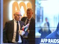 John Lyons, Executive Editor of ABC News, is followed by an Australian Federal Police officer as they walk out the main entrance to the ABC building located at Ultimo in Sydney