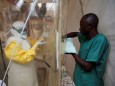 A health worker wearing Ebola protection gear enters the Biosecure Emergency Care Unit at the ALIMA Ebola treatment centre in Beni