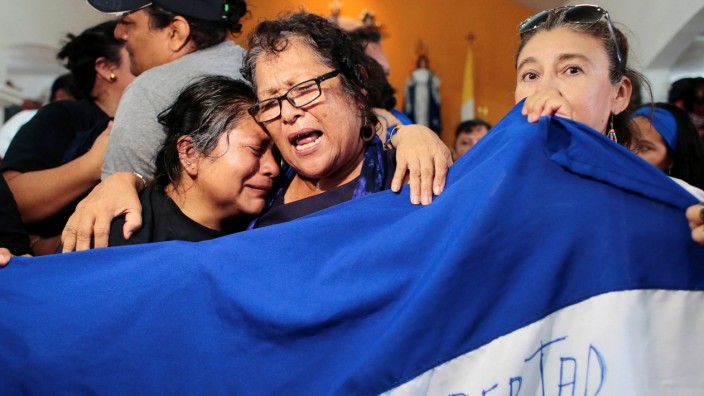 Women cry during a religious service for 56 political prisoners who were released under a new law that frees people who were arrested in recent protests against Nicaraguan President Daniel Ortega's government, in Masaya