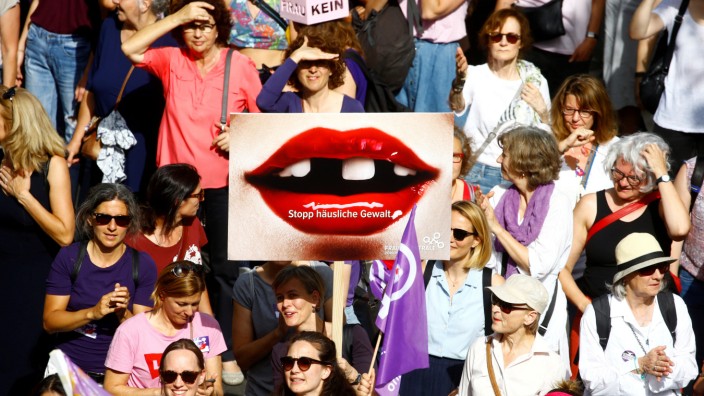 A protester carries a placard reading 'Stop domestic abuse' at a demonstration during a women's strike (Frauenstreik) in Zurich