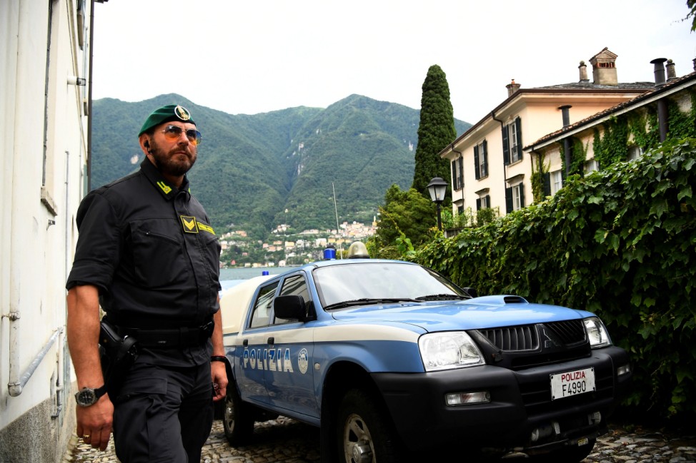 Italian Finance Police personnel stands near Villa Oleandra, the home of U.S. movie star George Clooney, ahead of the arrival of the Obama family in the northern Italian lakefront hamlet of Laglio