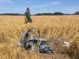 A forest official stands next to debris after two Eurofighter warplanes crashed after a mid-air collision near the village of Jabel in northeastern Germany