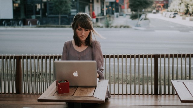 Banken: Eine Frau arbeitet in der Öffentlichkeit an ihrem Laptop. Aber wer liest mit, wenn sie online geht?