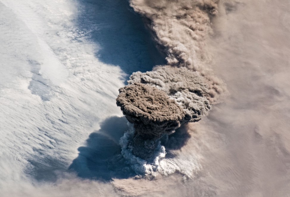A NASA handout photo of a large volcanic ash and gas plume taken from the International Space Station of the Raikoke Volcano above the Kuril Islands