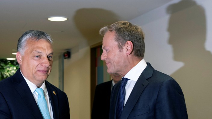 European Council President Donald Tusk speaks with Hungarian Prime Minister Viktor Orban prior to a meeting on the sidelines of an EU summit in Brussels