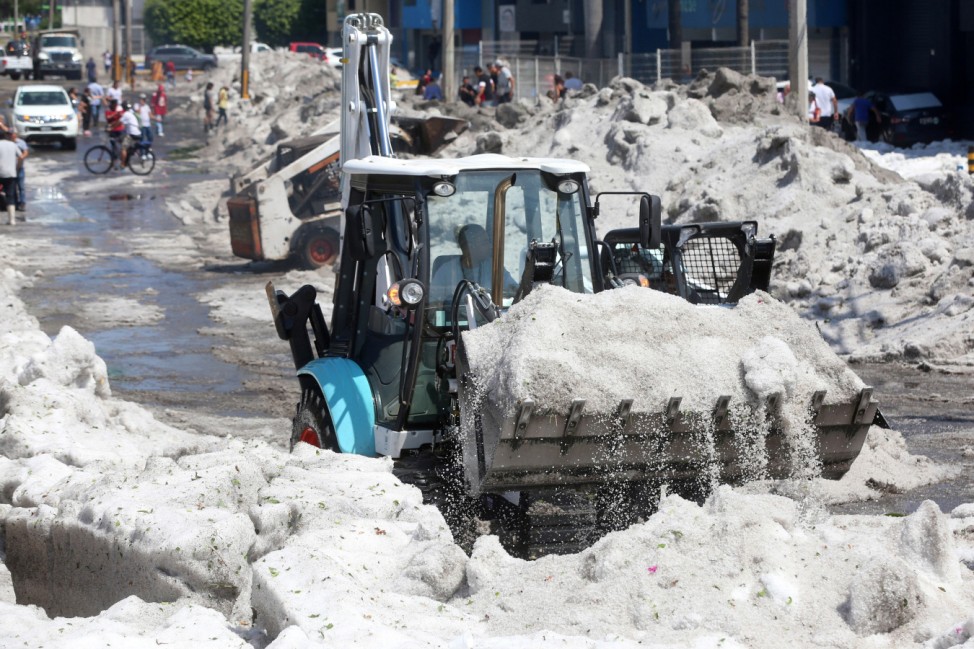 A truck carries ice as it cleans the street after a heavy storm of rain and hail which affected some areas of the city in âÄ'âÄ'Guadalajara,