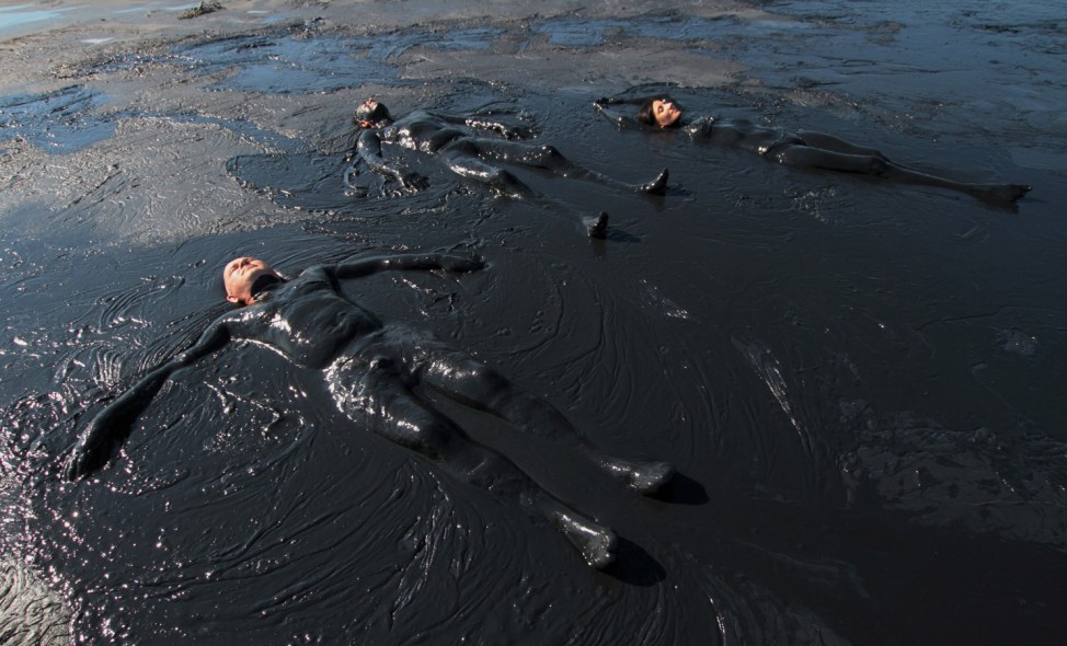 People take a mud bath in the Chokrak lake in Crimea