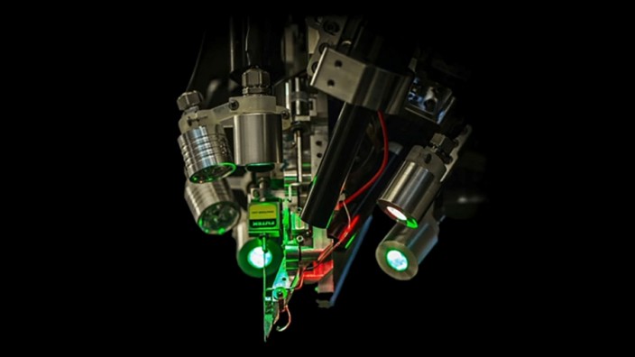 A robot used to implant threads is seen in a still image from video provided by Neuralink