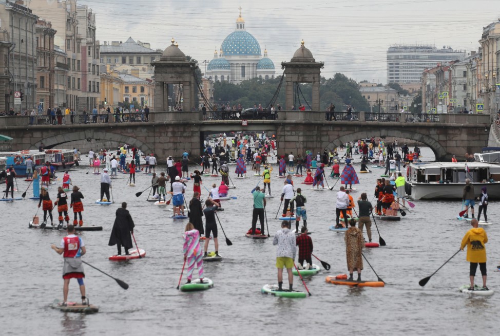 Paddlers take part in the Fontanka-SUP stand up paddle boarding festival in Saint Petersburg