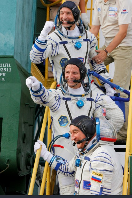 U.S. astronaut Andrew Morgan, Russian cosmonaut Alexander Skvortsov and Italian astronaut Luca Parmitano wave as they board prior the launch of Soyuz MS-13 spacecraft Baikonur cosmodrome
