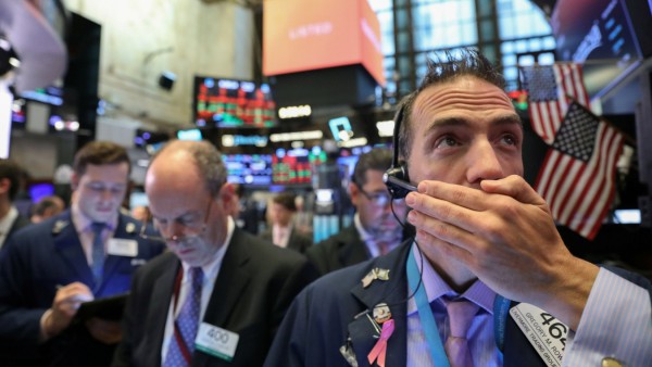 Traders work on floor of New York Stock Exchange (NYSE) after opening bell in New York