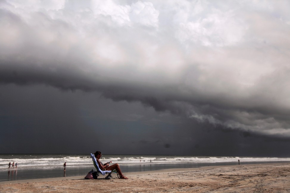 Tricia Cheshire, a resident of Amelia Island sunbathes for the last few minutes before storms hit the coast before Hurricane Dorian in Jacksonville, Florida