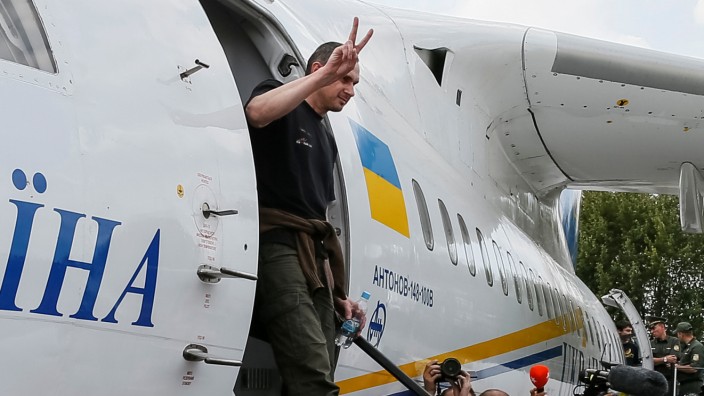 Ukrainian film director Sentsov, who was jailed on terrorism charges in Russia, gets off a plane upon arrival at Boryspil International Airport in Kiev