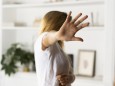 Abuse and violence against women woman raising hand at home model released Symbolfoto property rel